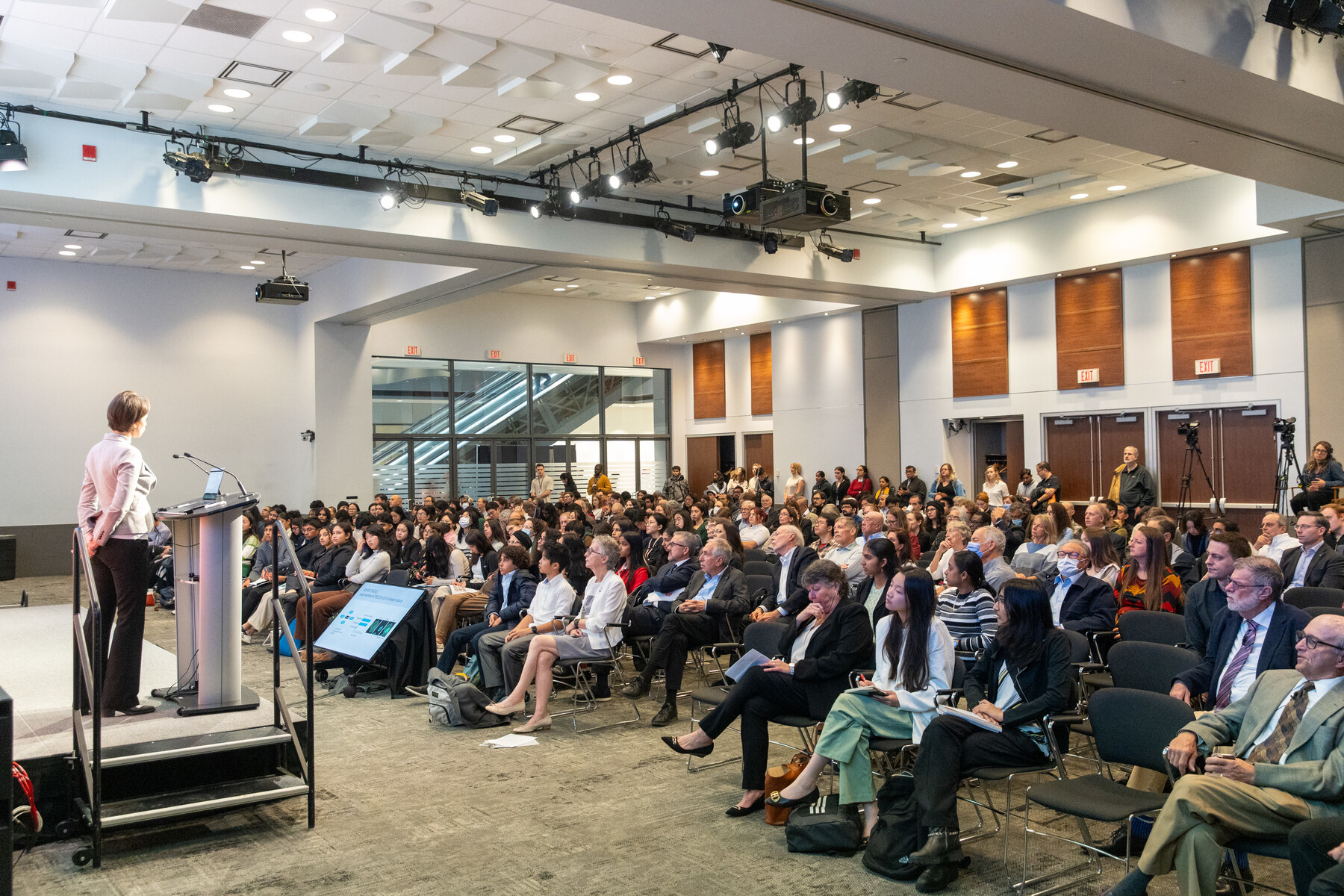 Shot from behind the stage of Elena Kuzmin addressing audience at Gairdner Science Week 2023