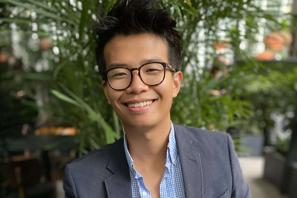 Young Asian man wearing glasses and in a suit