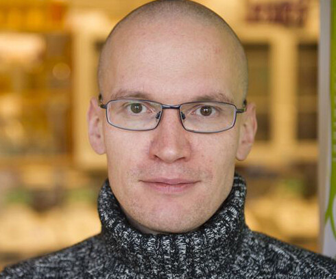 headshot of man wearing glasses