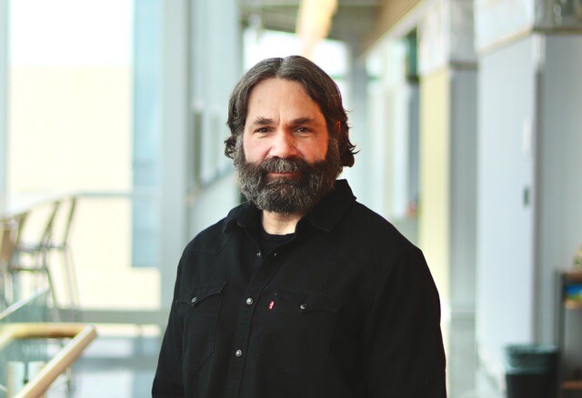 white man with a beard wearing dark shirt