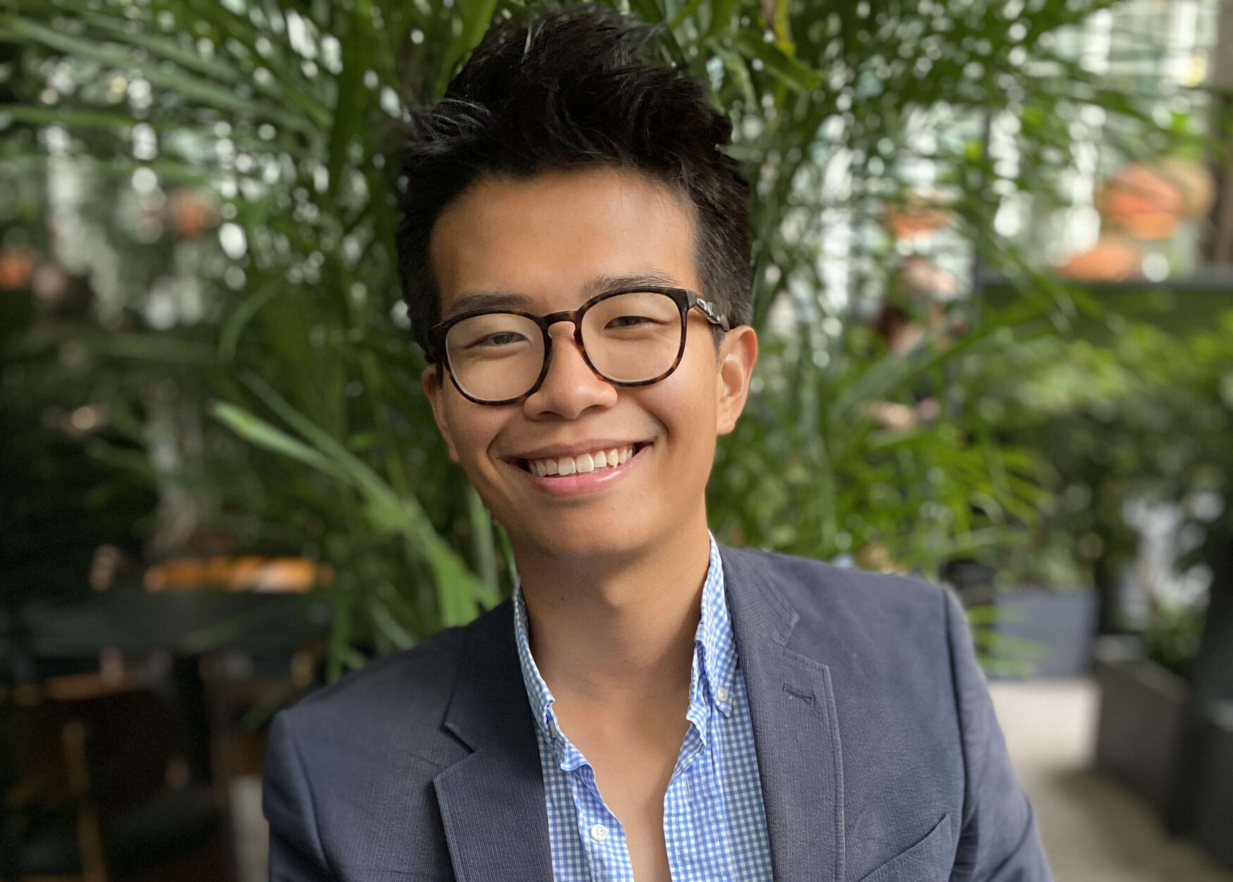 Young Asian man wearing glasses and in a suit