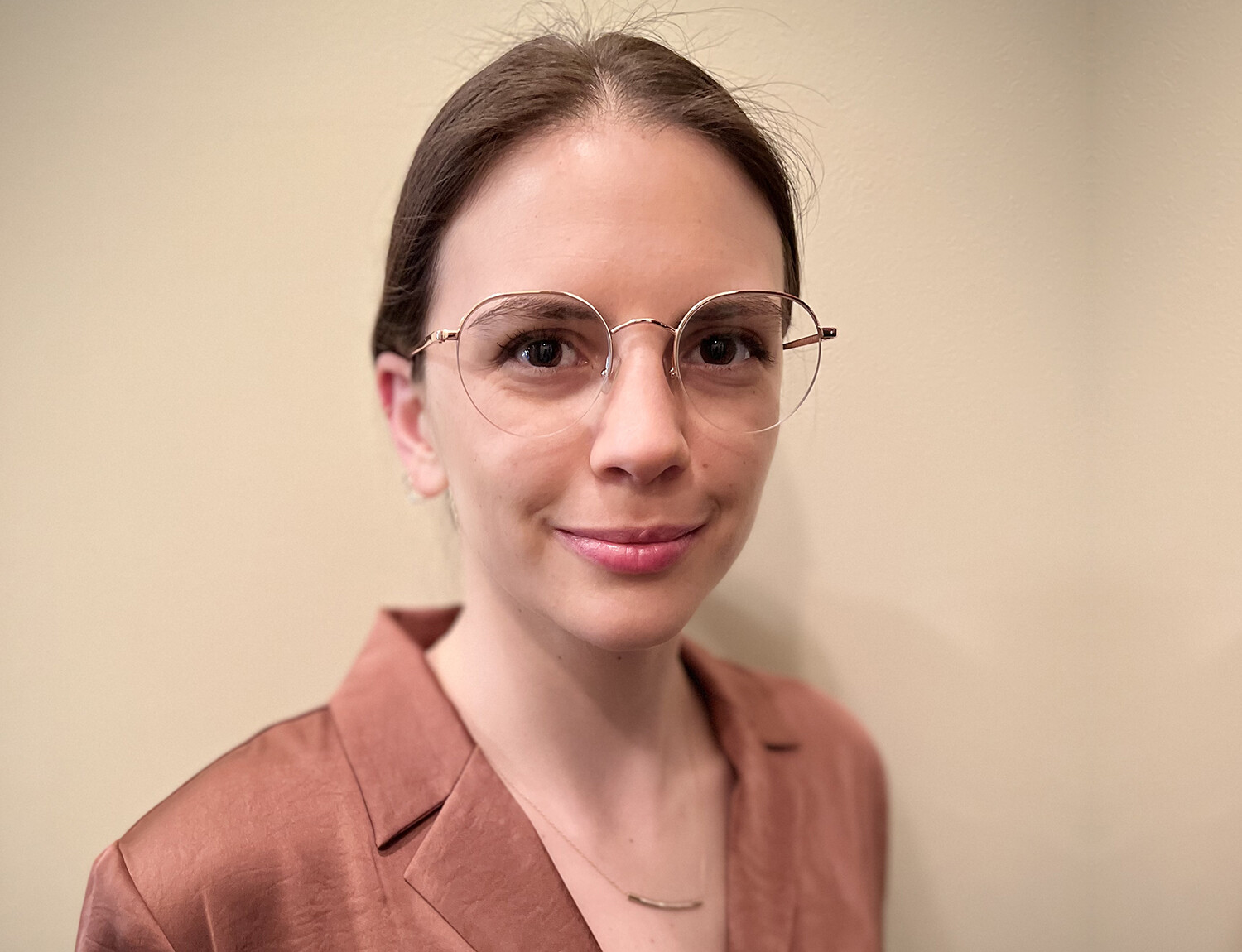 white bespectacled female with hair tied in ponytail